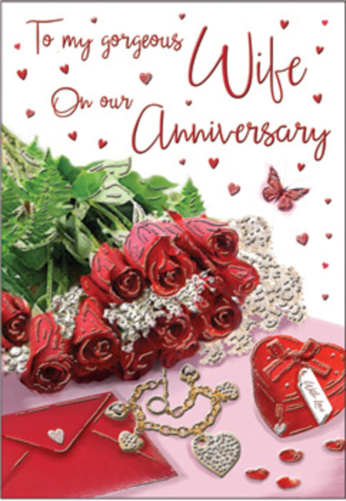 A richly romantic still life unfolds on this anniversary card, evoking the cozy charm of an evening spent together in Brockley. At the centre is an exquisite cluster of classic red roses, their blooms fully open, with petals that curl back in soft, velvety folds. Each rose appears almost tangible, as if you could lean in and breathe in that familiar deep, sweet fragrance. They sit cradled by lush green foliage, whose darker tones make the crimson petals glow with extra intensity, much like roses brought in fresh from a local Brockley florist. Around the base of this bouquet, intricate details tell their own quiet story: a vivid red box, its surface smooth and slightly glossy, suggests a special gift exchanged over the years, perhaps a cherished piece of jewellery. Next to it lies a delicate jewellery set, small but radiant, capturing pinpoints of light that sparkle against the softer background. Subtle heart-shaped motifs and lace-like patterns are woven into the design, echoing the tender traditions of anniversaries celebrated in familiar neighbourhood spots along Brockley Road or near Telegraph Hill. The card's scripted message, while not fully clear, flows across the scene in gentle curves and loops, its elegant lettering adding another layer of romance. Textures of velvet, satin, and polished metal all seem to coexist in this composition, creating a tactile richness that feels like a warm embrace. The overall mood is serene and heartfelt, suggesting an anniversary marked not only by grand gestures, but also by the quiet comfort of someone who knows your stories, your habits, and your heart.